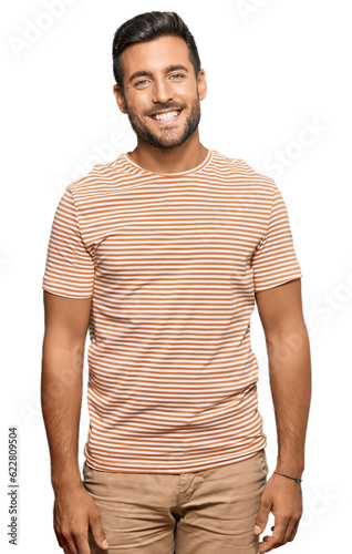 Handsome hispanic man wearing casual clothes with a happy and cool smile on face. lucky person.