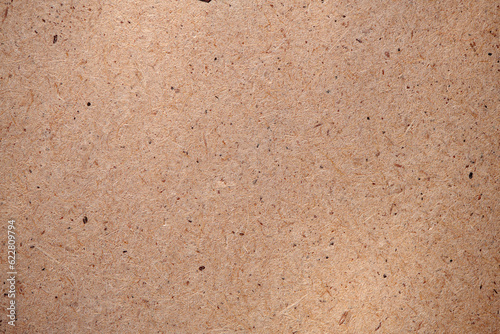 Hardboard surface for background or texture. Masonite Texture. Plywood hardboard background. Wooden board made of pressed sawdust. Top view.