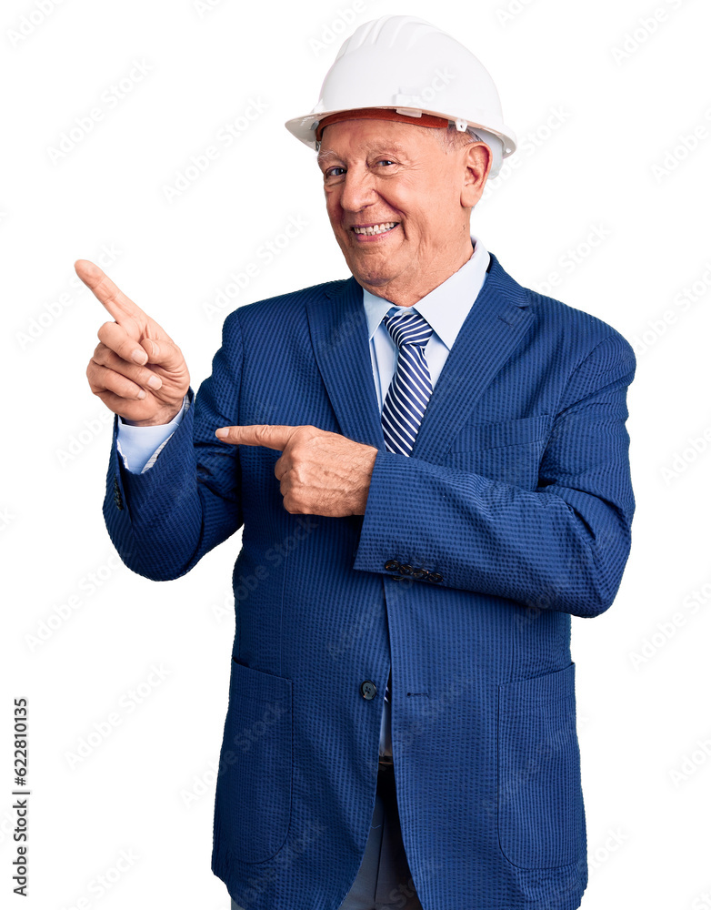 Senior handsome grey-haired man wearing suit and architect hardhat smiling and looking at the camera pointing with two hands and fingers to the side. Senior handsome grey-haired man wearing suit and architect hardhat smiling and looking at the camera pointing with two hands and fingers to the side.