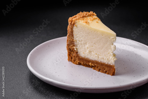Delicious sweet cheesecake cake on textured concrete background