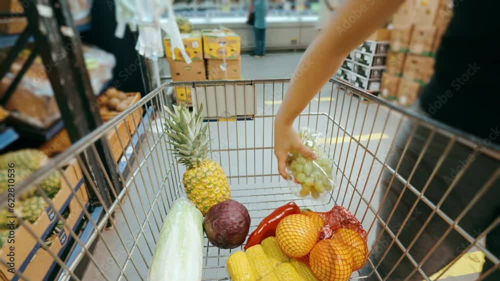 Shopping in the supermarket, filling the trolley with groceries, hyperlapse