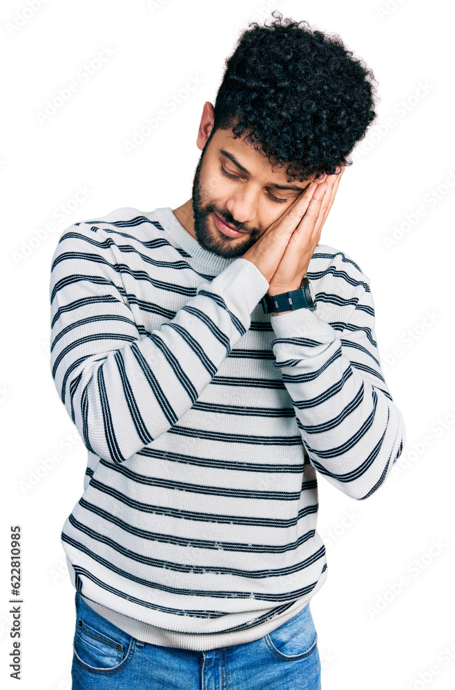 Young arab man with beard wearing casual striped sweater sleeping tired dreaming and posing with hands together while smiling with closed eyes. Young arab man with beard wearing casual striped sweater sleeping tired dreaming and posing with hands together while smiling with closed eyes.