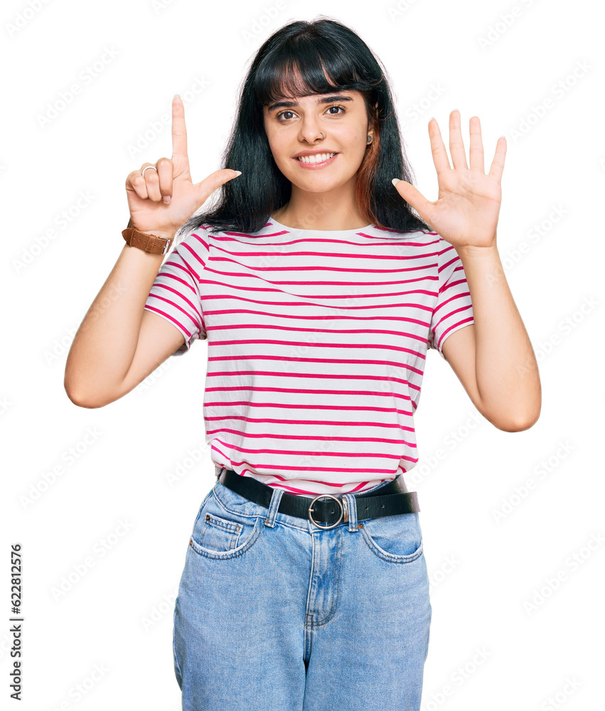Young hispanic girl wearing casual clothes showing and pointing up with fingers number seven while smiling confident and happy.
