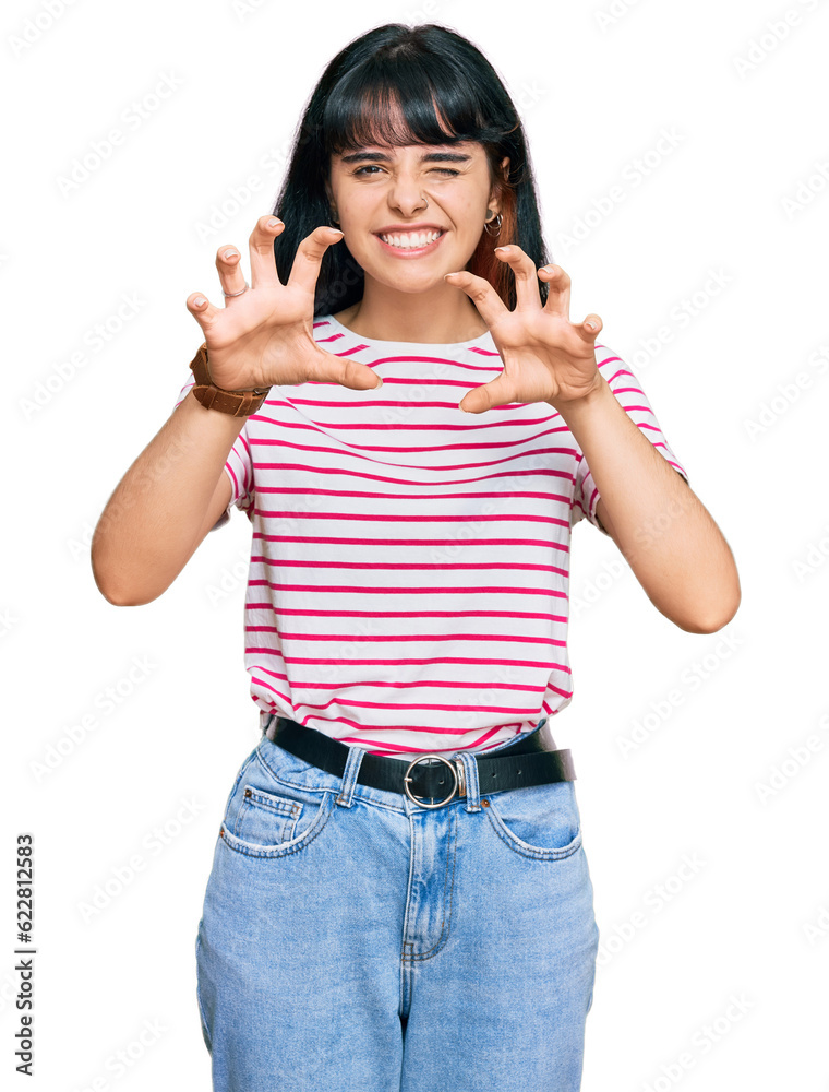 Young hispanic girl wearing casual clothes smiling funny doing claw gesture as cat, aggressive and sexy expression
