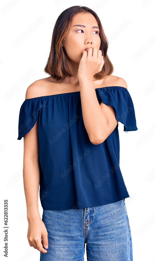 Young beautiful chinese girl wearing casual clothes looking stressed and nervous with hands on mouth biting nails. anxiety problem. Young beautiful chinese girl wearing casual clothes looking stressed and nervous with hands on mouth biting nails. anxiety problem.