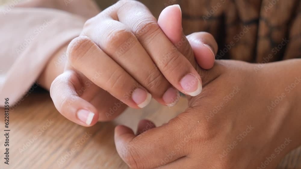 Young women suffering pain on thumb finger Young women suffering pain on thumb finger