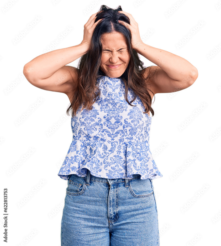 Young beautiful brunette woman wearing casual t-shirt suffering from headache desperate and stressed because pain and migraine. hands on head. Young beautiful brunette woman wearing casual t-shirt suffering from headache desperate and stressed because pain and migraine. hands on head.