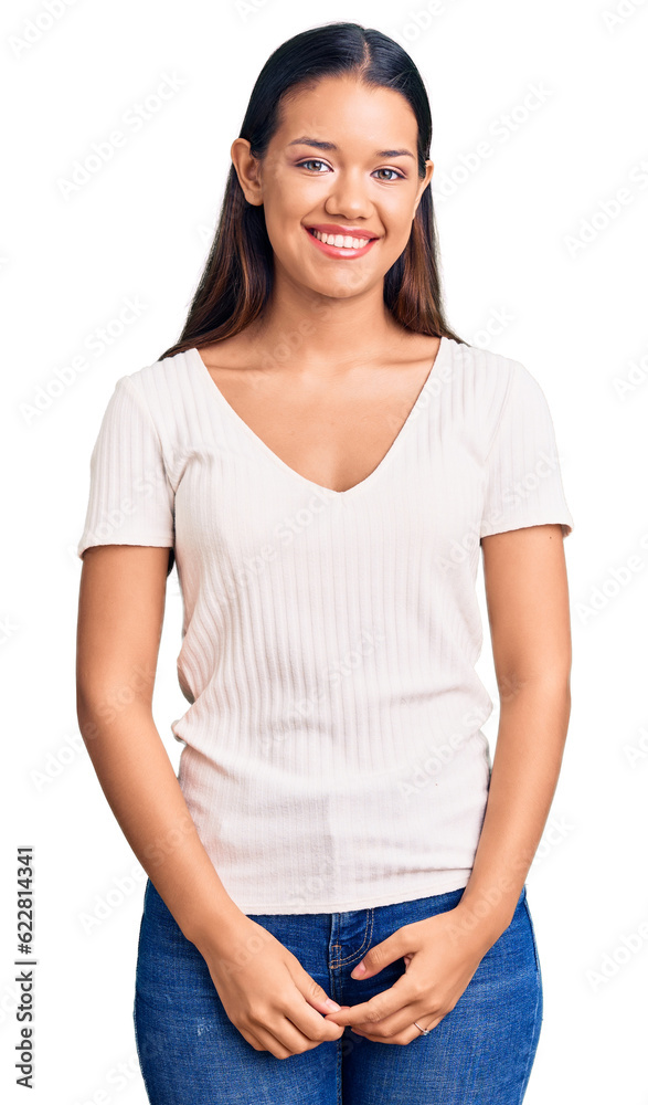 Young beautiful latin girl wearing casual white t shirt looking positive and happy standing and smiling with a confident smile showing teeth