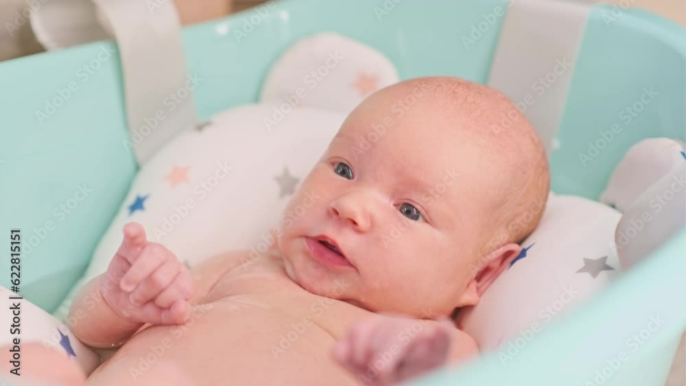 A newborn baby takes a bath. A lovely child is undergoing military training for the first time. The concept of children and hygiene A newborn baby takes a bath. A lovely child is undergoing military training for the first time. The concept of children and hygiene