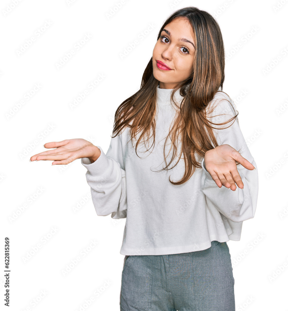 Young brunette woman wearing casual turtleneck sweater clueless and confused expression with arms and hands raised. doubt concept. Young brunette woman wearing casual turtleneck sweater clueless and confused expression with arms and hands raised. doubt concept.
