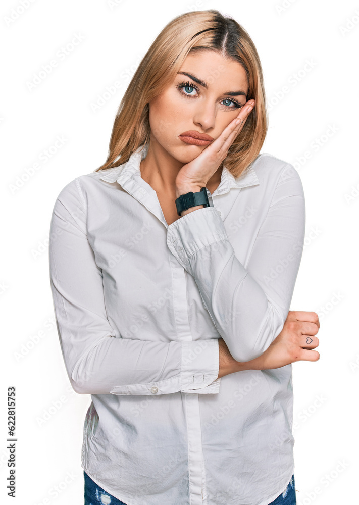 Young caucasian woman wearing casual clothes thinking looking tired and bored with depression problems with crossed arms. Young caucasian woman wearing casual clothes thinking looking tired and bored with depression problems with crossed arms.