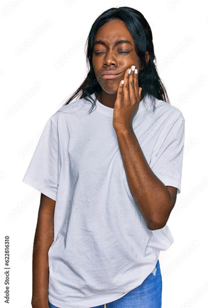 Young african american woman wearing casual white t shirt touching mouth with hand with painful expression because of toothache or dental illness on teeth. dentist Young african american woman wearing casual white t shirt touching mouth with hand with painful expression because of toothache or dental illness on teeth. dentist
