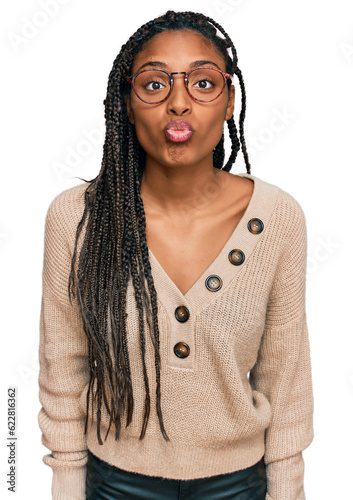 African american woman wearing casual clothes looking at the camera blowing a kiss on air being lovely and sexy. love expression.