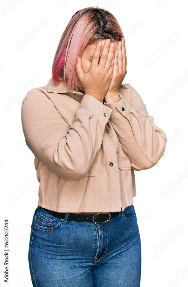 Hispanic woman with pink hair wearing casual clothes with sad expression covering face with hands while crying. depression concept. Hispanic woman with pink hair wearing casual clothes with sad expression covering face with hands while crying. depression concept.