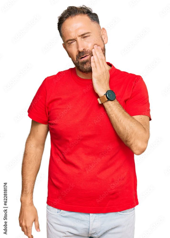 Handsome middle age man wearing casual red tshirt touching mouth with hand with painful expression because of toothache or dental illness on teeth. dentist