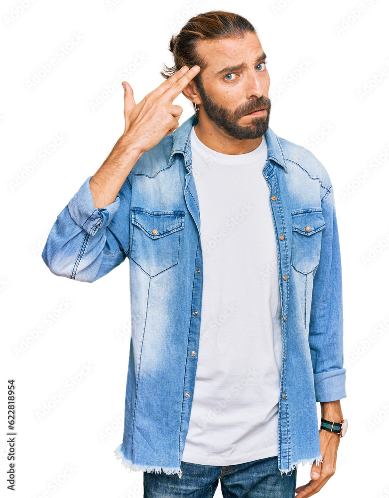 Attractive man with long hair and beard wearing casual denim jacket shooting and killing oneself pointing hand and fingers to head like gun, suicide gesture. Attractive man with long hair and beard wearing casual denim jacket shooting and killing oneself pointing hand and fingers to head like gun, suicide gesture.