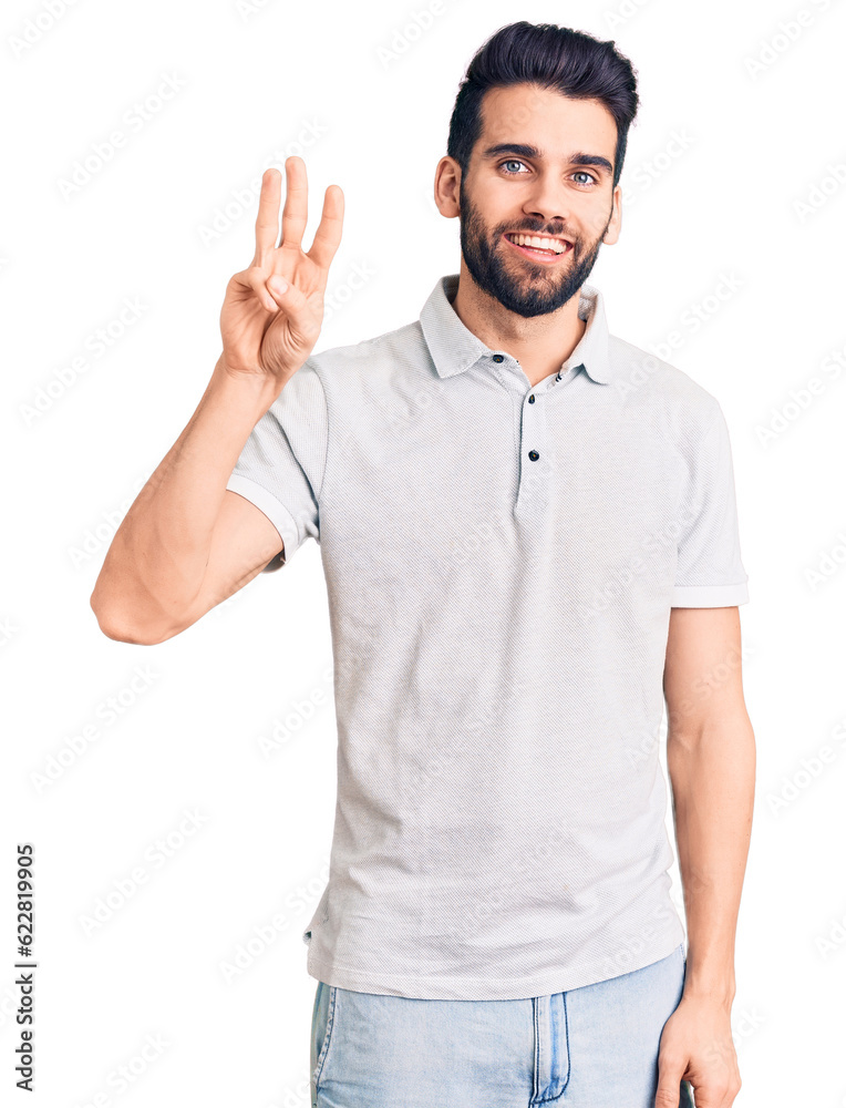 Young handsome man with beard wearing casual polo showing and pointing up with fingers number three while smiling confident and happy.
