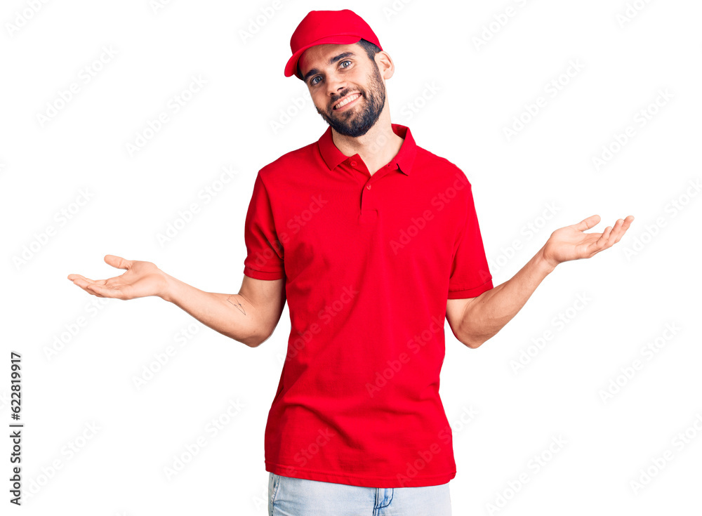 Young handsome man with beard wearing delivery uniform smiling showing both hands open palms, presenting and advertising comparison and balance Young handsome man with beard wearing delivery uniform smiling showing both hands open palms, presenting and advertising comparison and balance