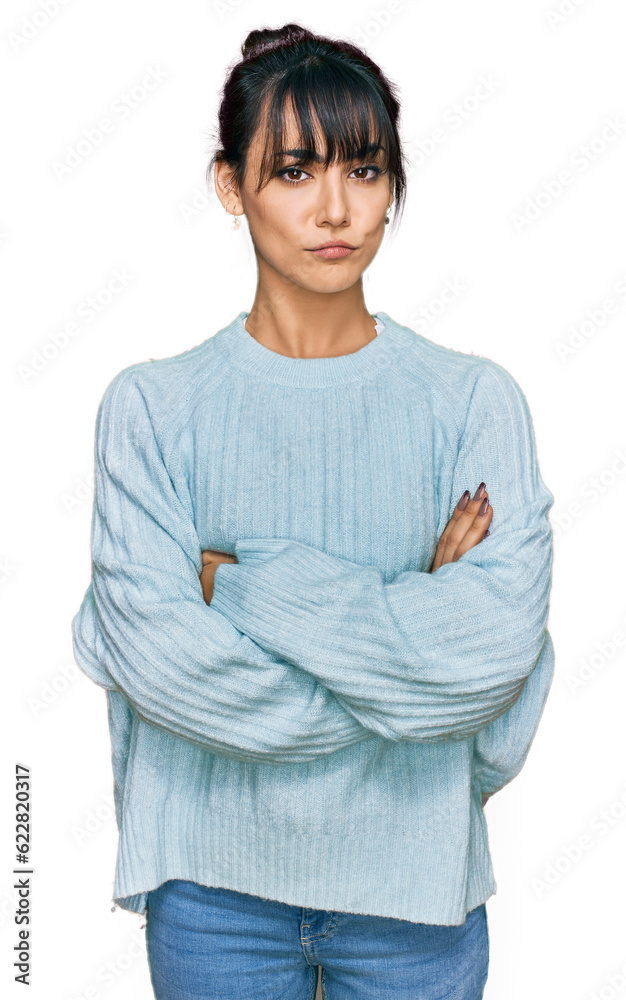 Young hispanic woman wearing casual clothes skeptic and nervous, disapproving expression on face with crossed arms. negative person. Young hispanic woman wearing casual clothes skeptic and nervous, disapproving expression on face with crossed arms. negative person.