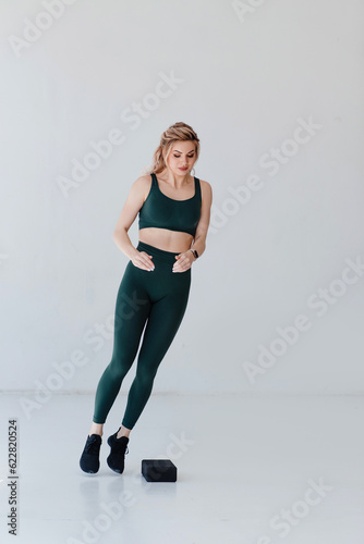 Vertical view of the athletic woman jumping over barrier