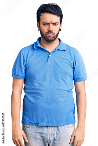 Young hispanic man wearing casual clothes skeptic and nervous, frowning upset because of problem. negative person.