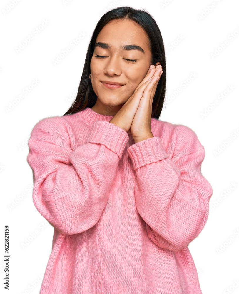 Young asian woman wearing casual winter sweater sleeping tired dreaming and posing with hands together while smiling with closed eyes. Young asian woman wearing casual winter sweater sleeping tired dreaming and posing with hands together while smiling with closed eyes.