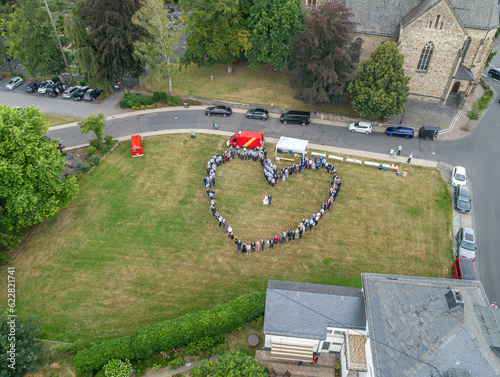 Wedding guests lined up in the shape of heart with bride and groom marriage people photo