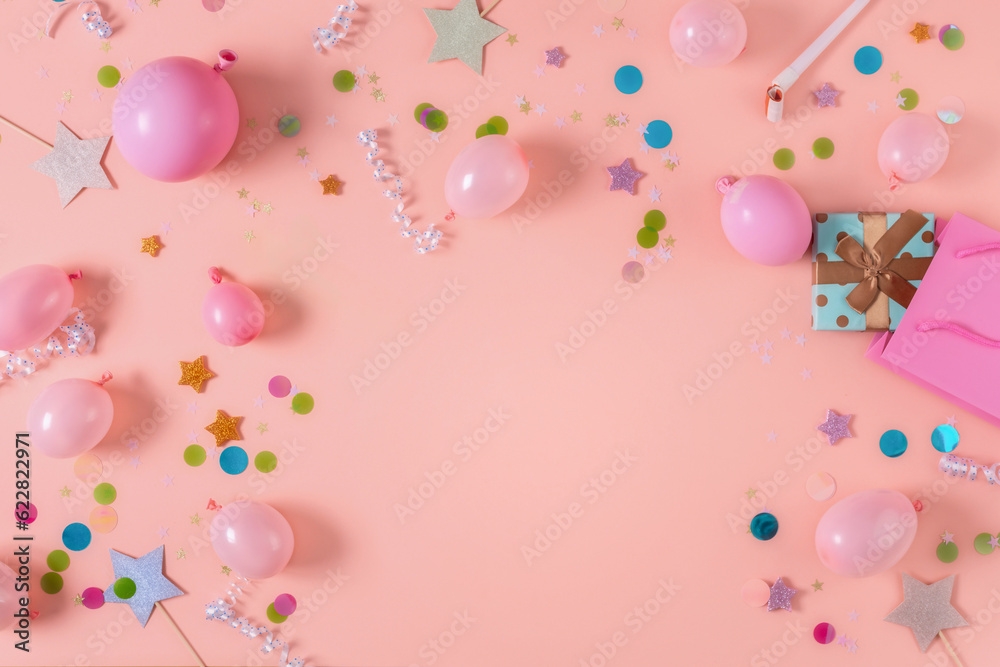 Frame of decoration party on a pastel pink background top view