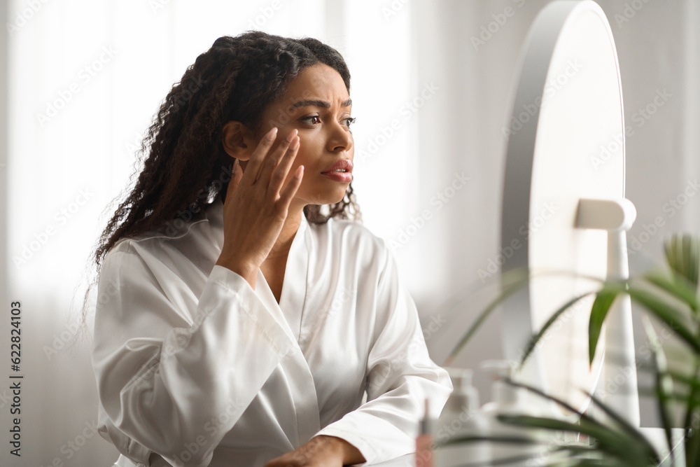 Aging Signs. Stressed Black Woman Touching Face Skin And Looking At Mirror Aging Signs. Stressed Black Woman Touching Face Skin And Looking At Mirror