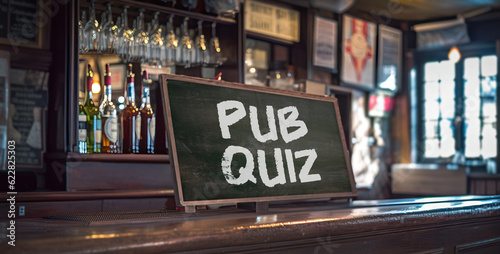 View of a pub with a chalk board on the counter that says Pub Quiz