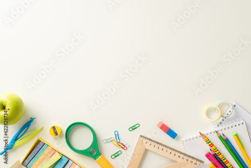 Unlock the potential of the educational process with this top-view photograph showcasing school supplies on an isolated white backdrop. Utilize the copy-space for text or promotional messages