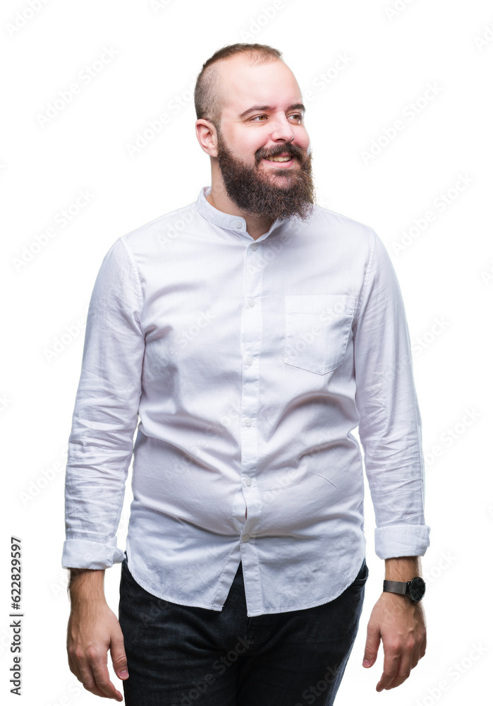 Young caucasian hipster man over isolated background looking away to side with smile on face, natural expression. Laughing confident. Young caucasian hipster man over isolated background looking away to side with smile on face, natural expression. Laughing confident.