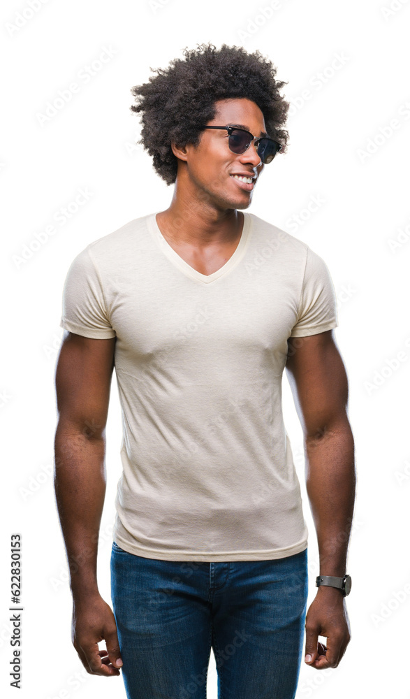 Afro american man wearing sunglasses over isolated background looking away to side with smile on face, natural expression. Laughing confident.