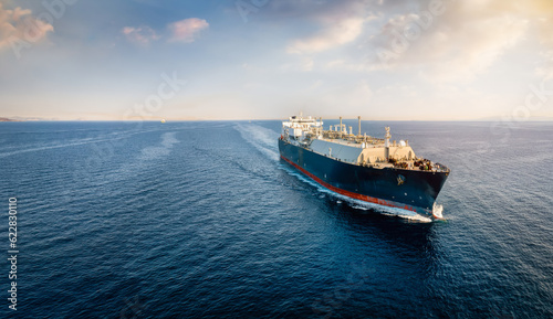 Print op canvas A big LNG tanker ship travelling over the calm ocean during sunset as a concept