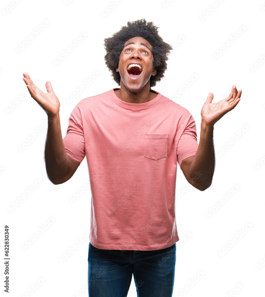 Afro american man over isolated background celebrating crazy and amazed for success with arms raised and open eyes screaming excited. Winner concept Afro american man over isolated background celebrating crazy and amazed for success with arms raised and open eyes screaming excited. Winner concept