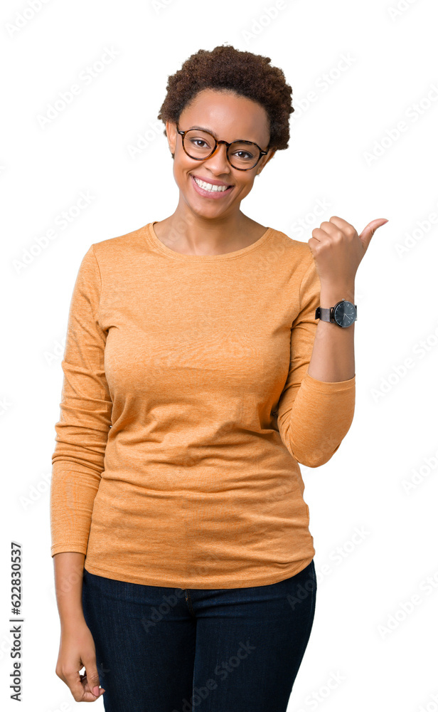 Young beautiful african american woman wearing glasses over isolated background smiling with happy face looking and pointing to the side with thumb up.