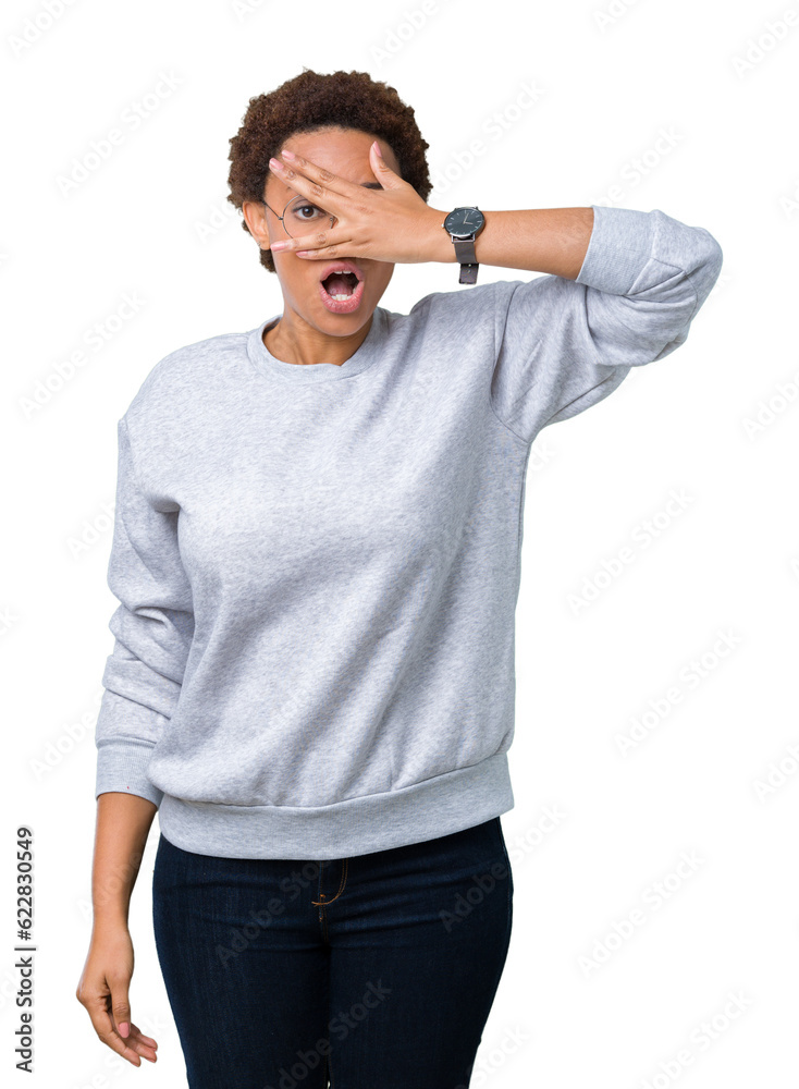 Fototapeta premium Young beautiful african american woman wearing glasses over isolated background peeking in shock covering face and eyes with hand, looking through fingers with embarrassed expression.