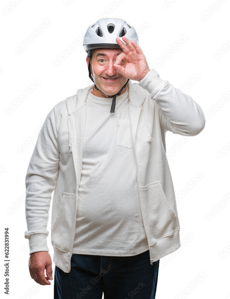Handsome senior cyclist man wearing bike helmet over isolated background with happy face smiling doing ok sign with hand on eye looking through fingers Handsome senior cyclist man wearing bike helmet over isolated background with happy face smiling doing ok sign with hand on eye looking through fingers