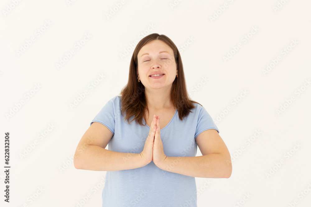 Worried young woman praying god with folded hands teenager girl asking god for help Pretty young business woman beg for mercy with eyes closed Isolated on white background Worried young woman praying god with folded hands teenager girl asking god for help Pretty young business woman beg for mercy with eyes closed Isolated on white background