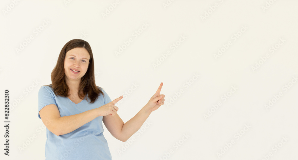 Professional smiling young woman help customer find where go, showing way, pointing finger right and grinning friendly, pleased to answer any questions as introduce new product, white background Professional smiling young woman help customer find where go, showing way, pointing finger right and grinning friendly, pleased to answer any questions as introduce new product, white background