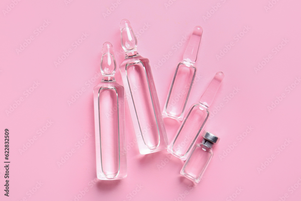 Medical ampules on pink background Medical ampules on pink background