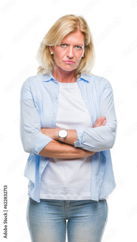 Middle age blonde woman over isolated background skeptic and nervous, disapproving expression on face with crossed arms. Negative person. Middle age blonde woman over isolated background skeptic and nervous, disapproving expression on face with crossed arms. Negative person.