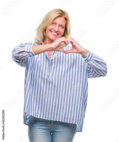 Middle age blonde business woman over isolated background smiling in love showing heart symbol and shape with hands. Romantic concept.