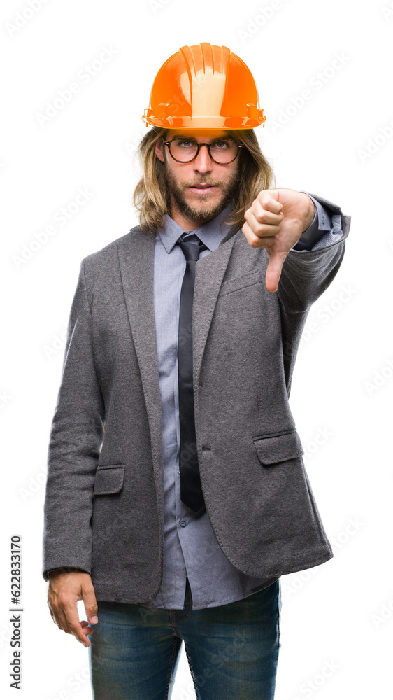Young handsome architec man with long hair wearing safety helmet over isolated background looking unhappy and angry showing rejection and negative with thumbs down gesture. Bad expression. Young handsome architec man with long hair wearing safety helmet over isolated background looking unhappy and angry showing rejection and negative with thumbs down gesture. Bad expression.