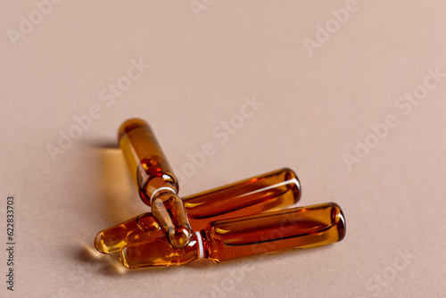 Glass ampules on brown background