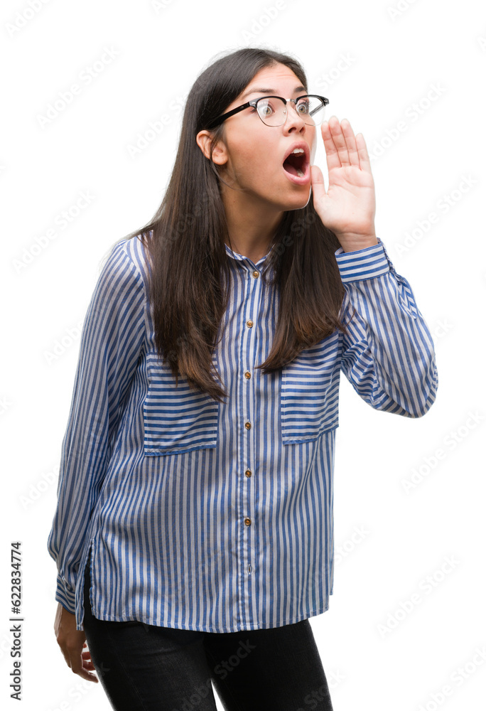 Young beautiful hispanic business woman shouting and screaming loud to side with hand on mouth. Communication concept. Young beautiful hispanic business woman shouting and screaming loud to side with hand on mouth. Communication concept.