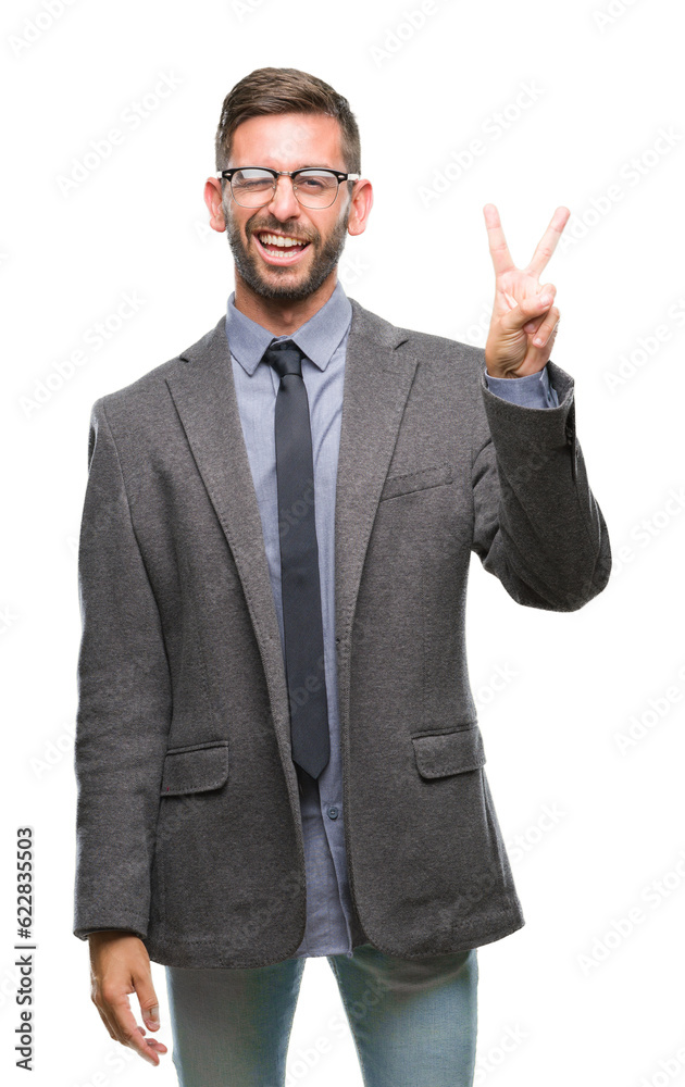 Young handsome business man over isolated background smiling with happy face winking at the camera doing victory sign. Number two.