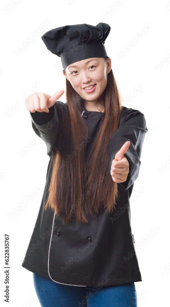 Young Chinese woman over isolated background wearing chef uniform approving doing positive gesture with hand, thumbs up smiling and happy for success. Looking at the camera, winner gesture. Young Chinese woman over isolated background wearing chef uniform approving doing positive gesture with hand, thumbs up smiling and happy for success. Looking at the camera, winner gesture.