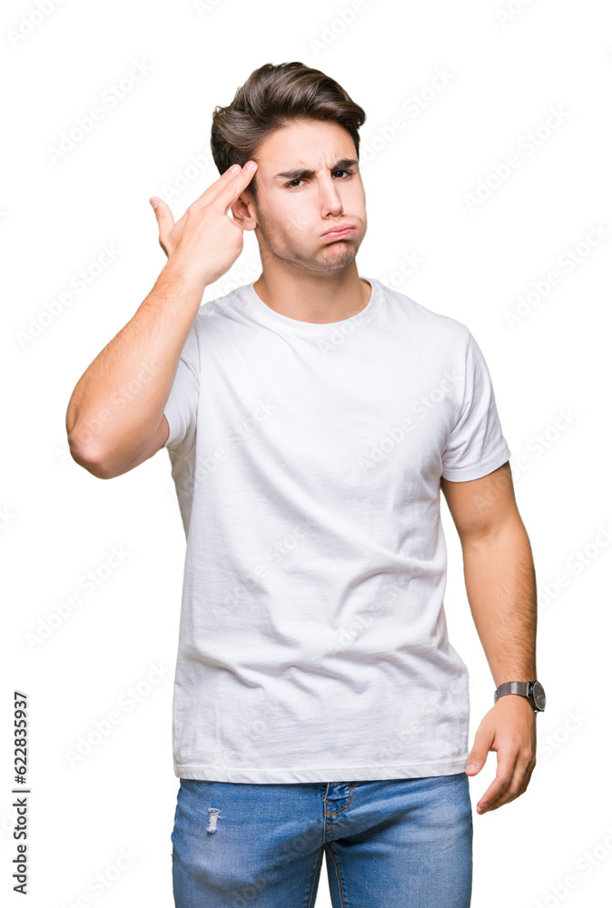 Young handsome man wearing white t-shirt over isolated background Shooting and killing oneself pointing hand and fingers to head, suicide gesture. Young handsome man wearing white t-shirt over isolated background Shooting and killing oneself pointing hand and fingers to head, suicide gesture.