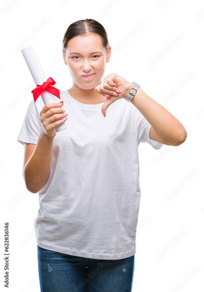Young caucasian woman holding degree over isolated background with angry face, negative sign showing dislike with thumbs down, rejection concept Young caucasian woman holding degree over isolated background with angry face, negative sign showing dislike with thumbs down, rejection concept
